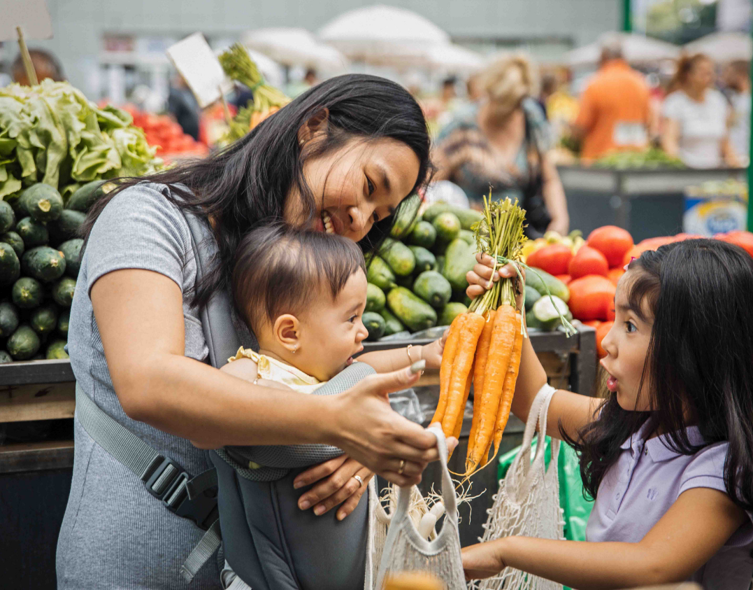 Mom with daughter and baby at food store photo