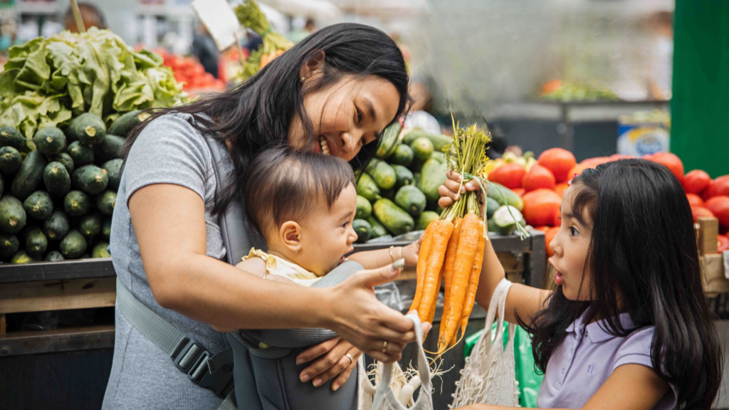 Mom with daughter and baby at food store photo